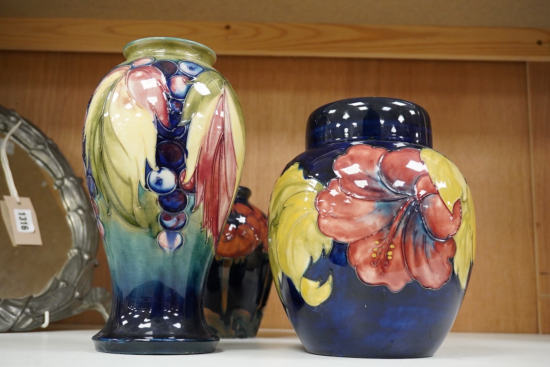 Three Moorcroft vases and a Moorcroft Hibiscus jar and cover, largest 25cm high